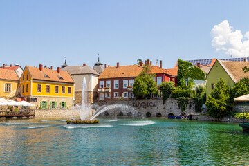 Obraz premium A town of Tapolca in Balaton region of Hungary with lake in the middle of the city and fountain, carps in the lake