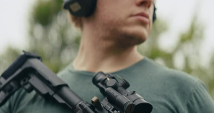 Portraits of a young man at a gun range