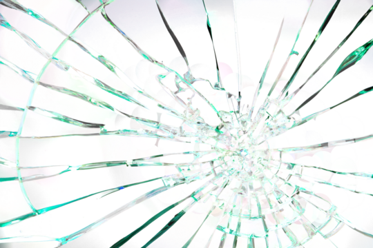 A shattered glass window with a green tint