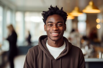 Fototapeta premium Portrait of a smiling young male waiter in restaurant