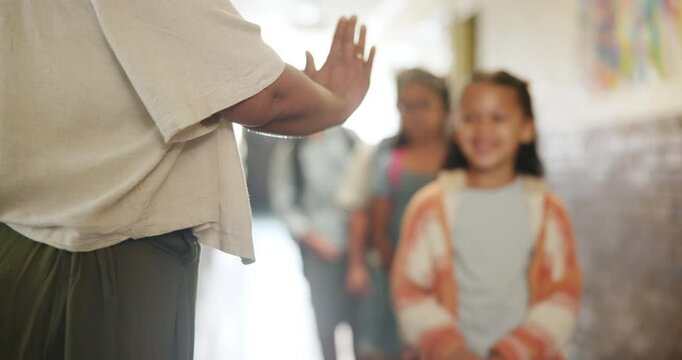 Greeting, children and high five teacher in school for enter classroom, learning and education for growth or development. Girl, boys and students fist bump for welcome, motivation and morning routine