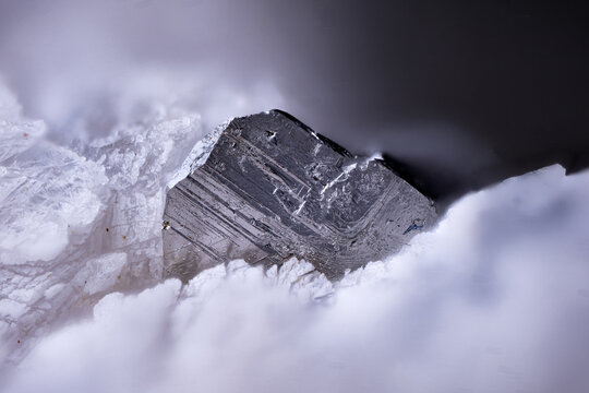Native bismuth on white chondrodite. Micro photography extreme close-up. Specimen from Conchita Mine, Spain. microscope photography for Scientific use.
