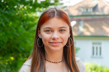 Young teenage girl outdoors in front of the house