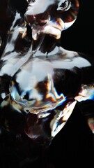 The crystal figure of a muscular athlete in a dynamic pose, he stretches his hand up