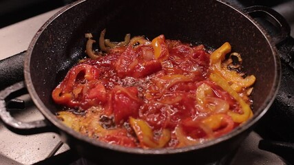 Close up footage of frying the red and yellow bell pepper slices in a frying wok - Powered by Adobe