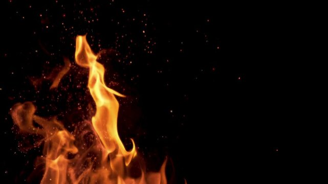 Flames flickering with sparks flying from a bonfire