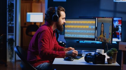 Photo editor using graphic tablet to edit images lighting and color balance, delivering visually appealing final product, listening to music. Freelancer wearing headphones browsing through photographs