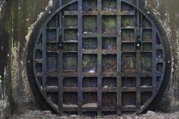 Large vault door that dumps raw sewage into the environment 