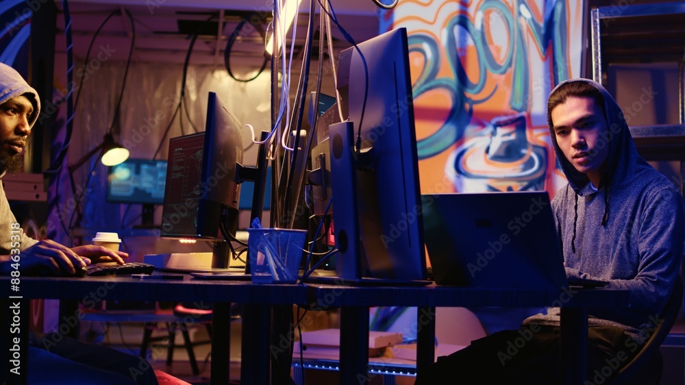 Poster asian hacker arriving in underground hq, ready to start coding malware designed to exploit network b