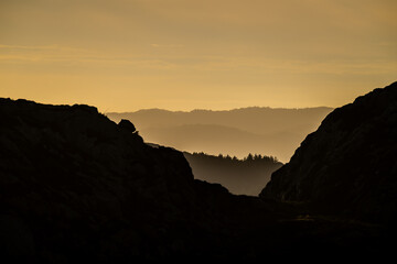 Sea haze in a rocky landscape at sunset.