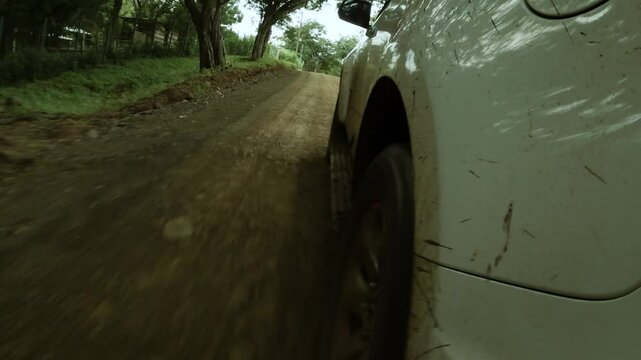 Point of view angle of SUV truck driving off-road and  kicking up mud 