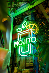 Cocktail glass in a neon light panel in a bar © unai