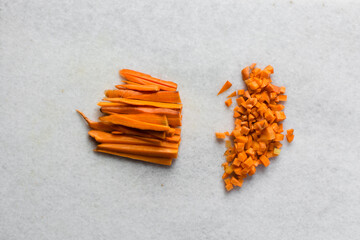 Overhead view of carrots being diced on a marble countertop, top view of sliced carrots, dicing...