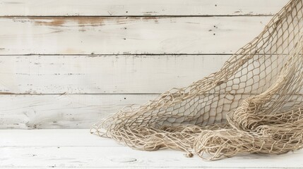 Artistic photograph of vintage fishing net on white wooden backdrop with empty space
