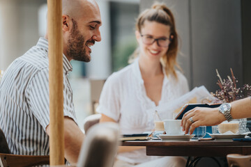 Startup team in a business meeting discussing, brainstorming, and strategizing while enjoying coffee at an outdoor cafe