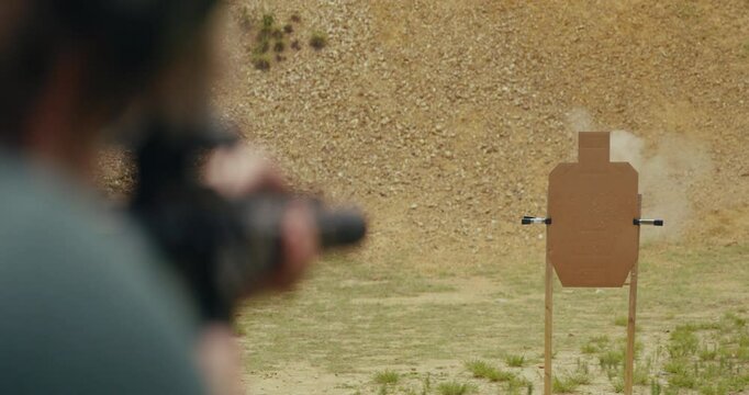 Young man shooting an AR-15