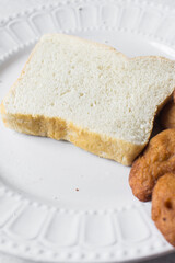 Akara and bread on a white plate, nigerian akara fried beans cake and bread on a plate