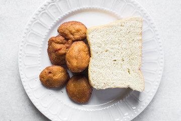 Akara and bread on a white plate, nigerian akara fried beans cake and bread on a plate