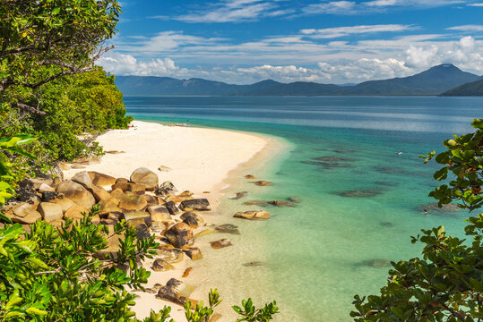Picturesque tropical golden Nudey Beach with turquoise water on Fitzroy Island. It is a continental island southeast of Cairns, Queensland, Australia.