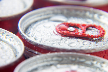 macro photography of wet canned beer lids