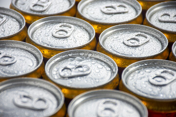 macro photography of wet canned beer lids