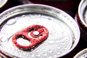 macro photography of wet canned beer lids
