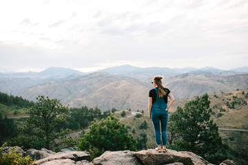 Girl in the mountains looking out