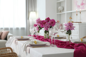 Beautiful table setting with pink peonies in dining room