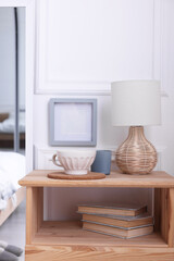 Obraz premium Stylish living room interior with bed, bedside table and lamp