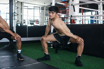 Two Asian Boxer Man Stretching Together With Bending Body And Holding Knee Before Workout For Wellness 