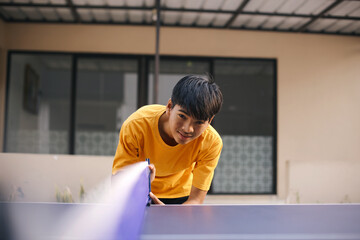 Young Asian Sportsman Preparing Net Before Playing Ping Pong Outdoor