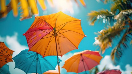 Obraz premium brightly colored umbrellas are in the air near palm trees