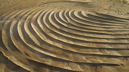 Patterns of circles and curved lines in sand at beach