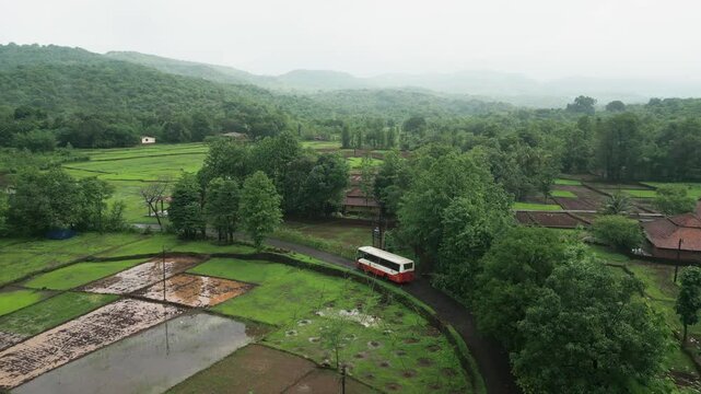 state transport bus going in forest in rainey season drone view in konkan