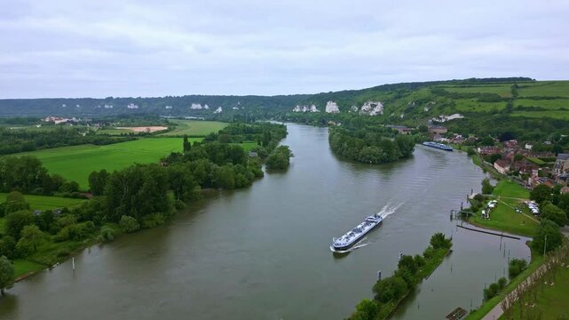 Les Andelys village and Seine River in department of Eure in Normandy, France. Aerial forward and sky for copy space