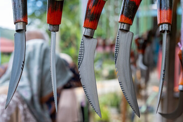 hunting knives, bayonet weapons, medium-sized knives hanging in the Indonesian Asian traditional...