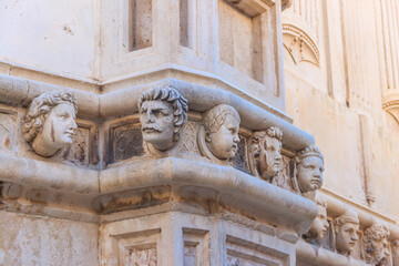 Stone heads on the side portal of The Cathedral of St. James in Sibenik, Croatia. Details of...