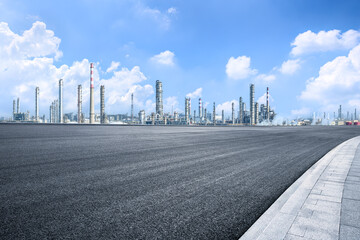 Empty asphalt road and industrial buildings background