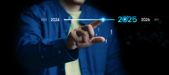 Countdown to 2025 concept. the taps a virtual download bar with a loading progress meter on New Year's Eve, turning the year 2024 to 2025.