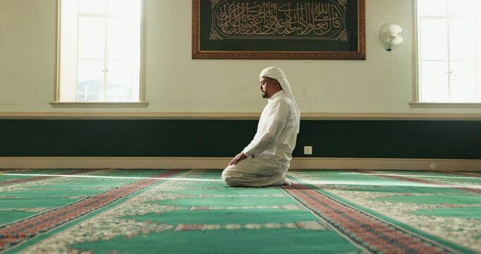 Muslim man, prayer or bow on carpet in Mosque for peace, gratitude or support to Allah in holy temple. Dua, Islamic or spiritual male person praying to worship God on Ramadan Kareem in Saudi Arabia
