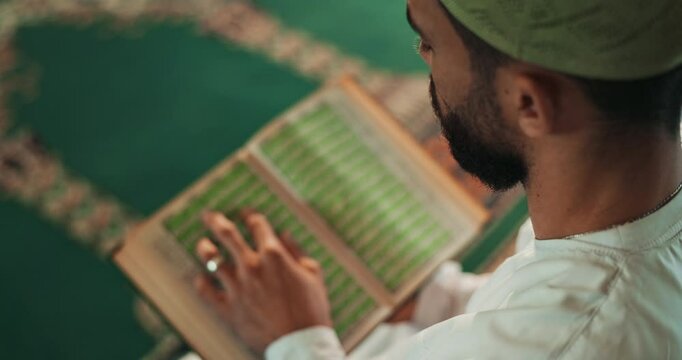 Muslim pray, Quran and hands of man at mosque with peace, hope and praise or gratitude to Allah top view. Islamic, worship or person with holy book, mindfulness and balance, thank you or religion