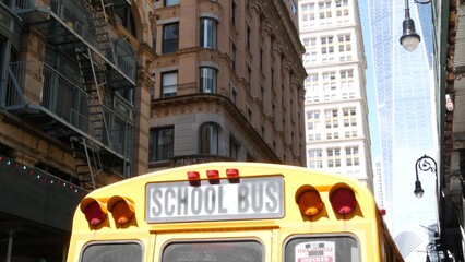 Yellow School Bus. Schoolbus back view on Fulton street, New York City Manhattan Downtown. Children education and transportation, USA. American school shuttle, World Trade Center tower, United States.