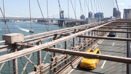 Cars on Brooklyn Bridge, New York City Manhattan Bridge view. Yellow taxi cab, road traffic and...