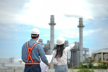 Planning engineering and project leader working and check Plans at Industrial Site on power plant. Survey location on site. 