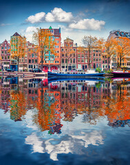 Colorful buildings of Amsterdam city reflected in the calm waters of famous Dutch canal. Amazing...