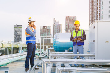 Team of HVAC engineer working in boiler rooftop, Engineer working in gas pipe boiler steam of...