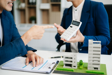balancing the property sector The real estate agent is explaining the house style to see the house...