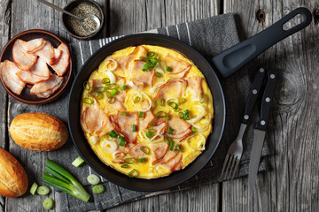 deli ham onion omelette on skillet, top view