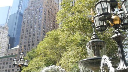 New York City Lower Manhattan, Downtown Financial District architecture, United States. High-rise buildings on Broadway street, USA. American urban scene, fountain in City Hall Park, NYC. Greenery.
