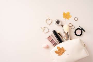 Flat lay image of various makeup products, accessories, and autumn leaves on a neutral background. Perfect for beauty, fashion, and seasonal concepts